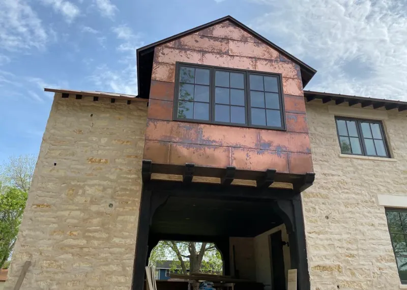 Copper metal panel facade on a stone building for Skylight Installation in Rantoul