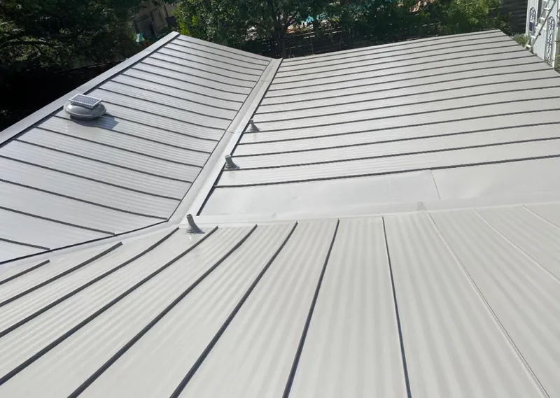 Solar attic fan installed on a metal roof for Roof Ventilation in Rantoul